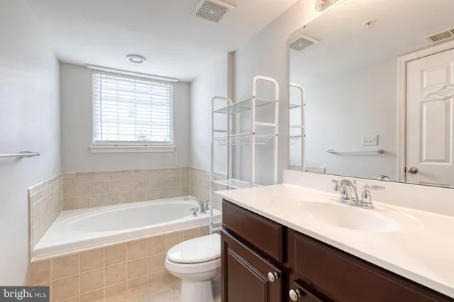 a bathroom with a shower sink and mirror