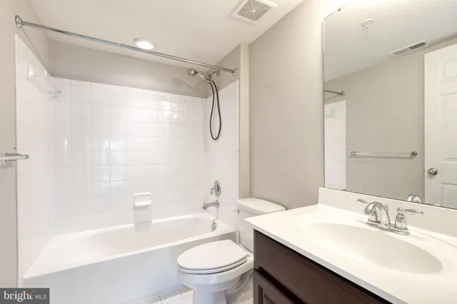 an empty room with windows and cabinet