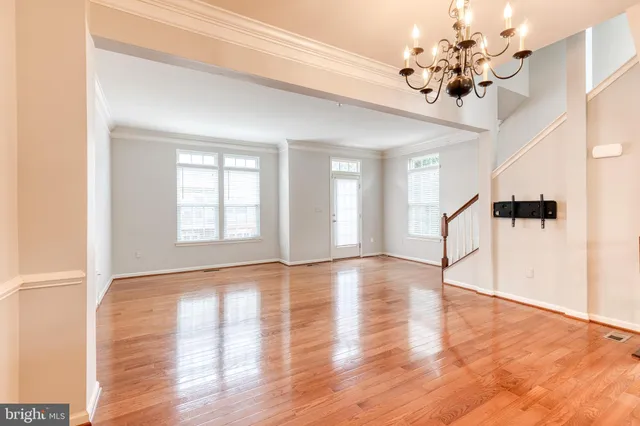 a view of a kitchen with furniture and wooden floor