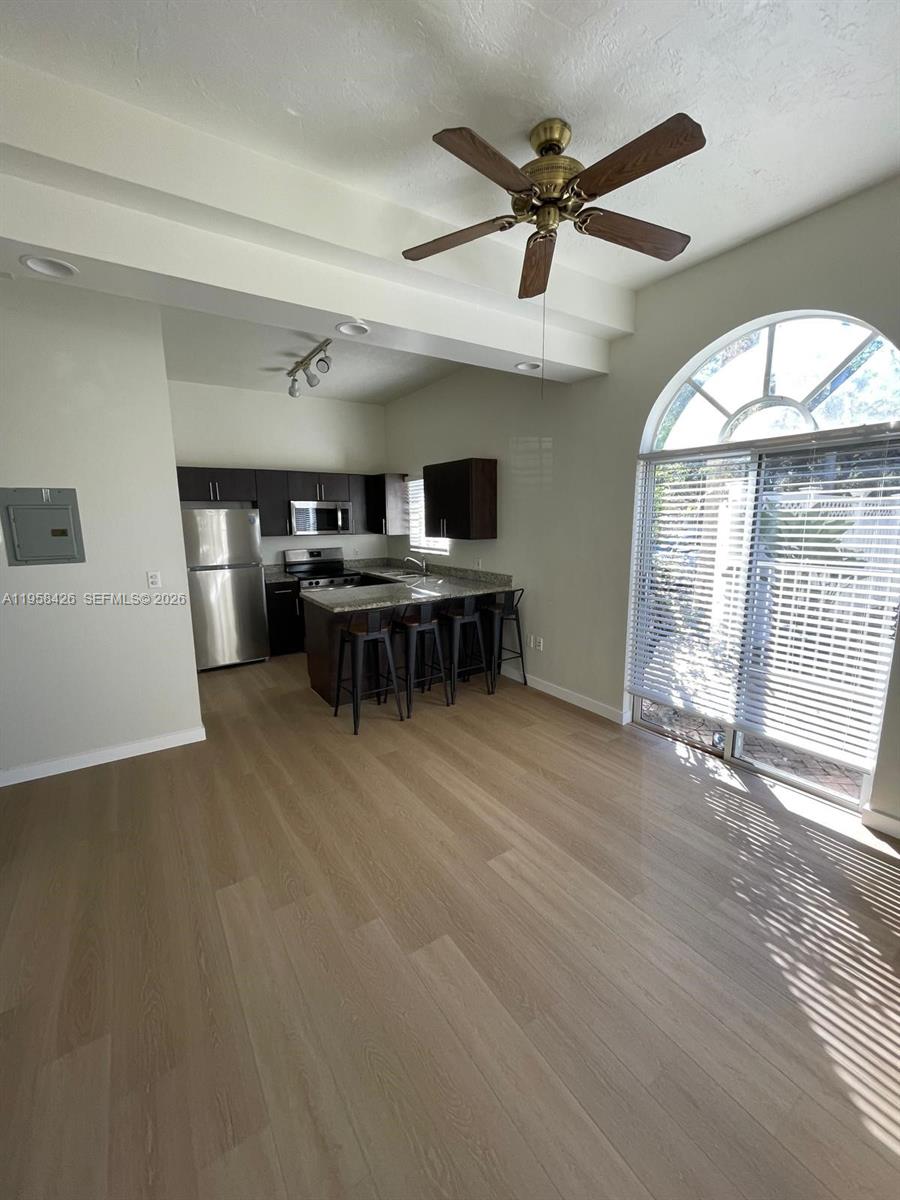 3356 Bird Avenue, Unit 5 Miami, FL 33133 - Photo 13 of 15 a view of a livingroom with furniture fan and wooden floor