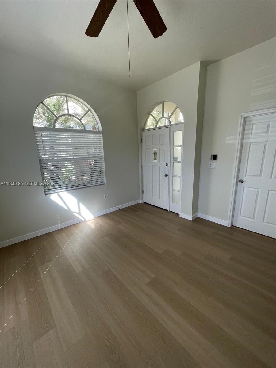 3356 Bird Avenue, Unit 5 Miami, FL 33133 - Photo 15 of 15 an empty room with wooden floor fan and windows