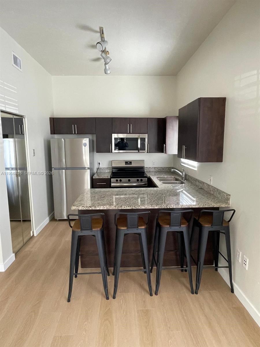 3356 Bird Avenue, Unit 5 Miami, FL 33133 - Photo 3 of 15 a kitchen with a table and chairs in it