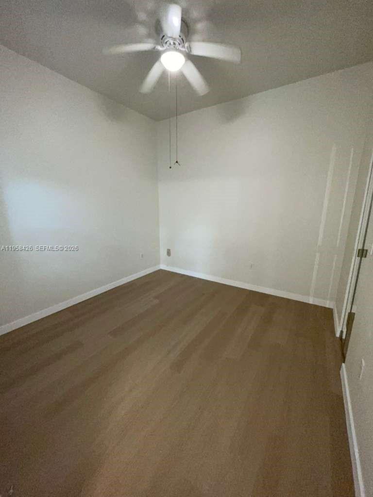 3356 Bird Avenue, Unit 5 Miami, FL 33133 - Photo 6 of 15 an empty room with a ceiling fan and carpet