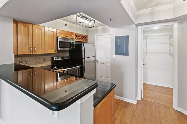a kitchen with stainless steel appliances granite countertop a sink refrigerator and microwave