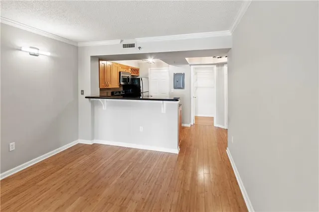 a view of a kitchen with wooden floor and a sink