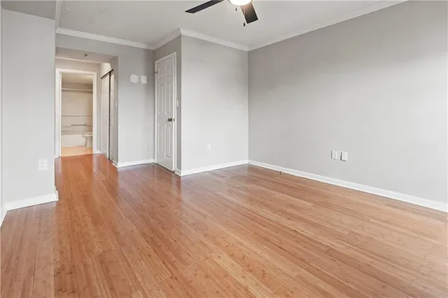 an empty room with wooden floor and closet