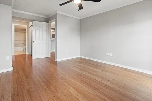a view of an empty room with wooden floor