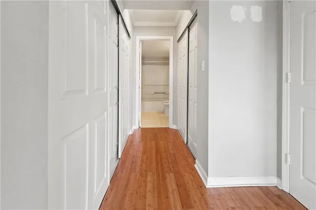 a view of hallway with wooden floor