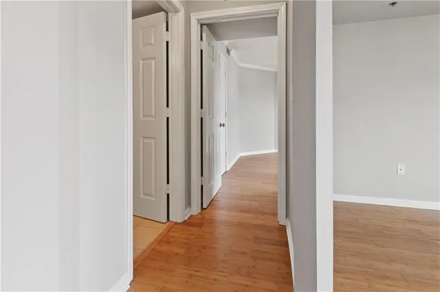 a view of a hallway with wooden floor