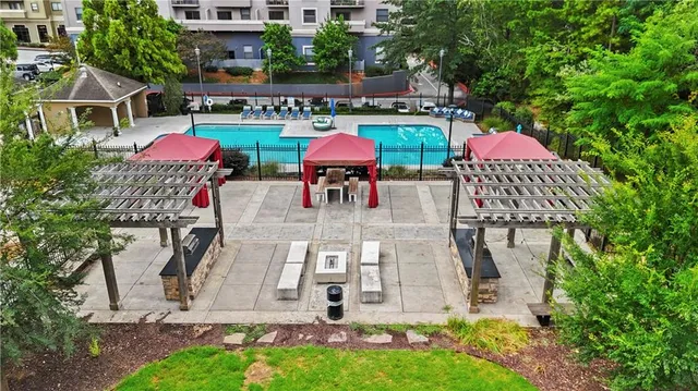 an aerial view of a house with yard and swimming pool