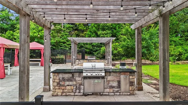 a view of backyard with swimming pool and outdoor seating