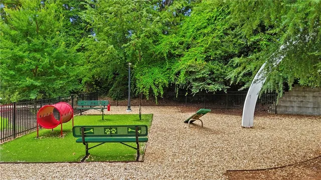 a backyard of a house with barbeque oven table and chairs