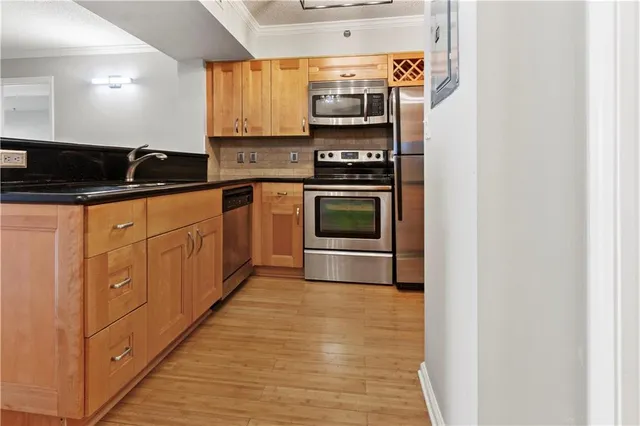 a kitchen with stainless steel appliances a stove and a microwave