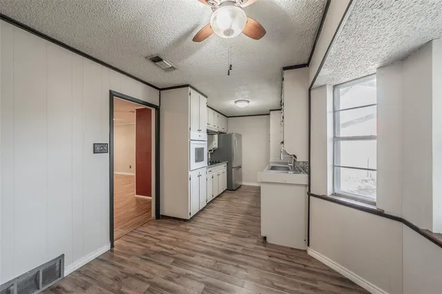 a kitchen with stainless steel appliances a refrigerator and a stove
