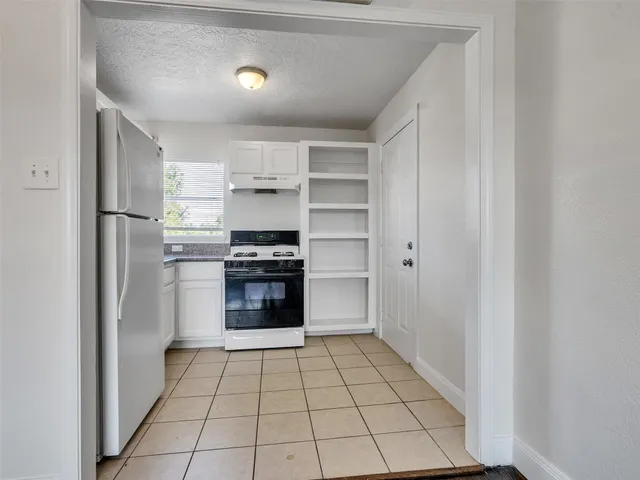 a kitchen with a cabinets and steel appliances