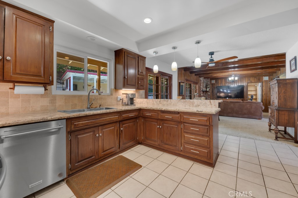 23714 Lawnside Drive Newhall, CA 91321 - Photo 17 of 48 a kitchen with stainless steel appliances granite countertop a sink and cabinets