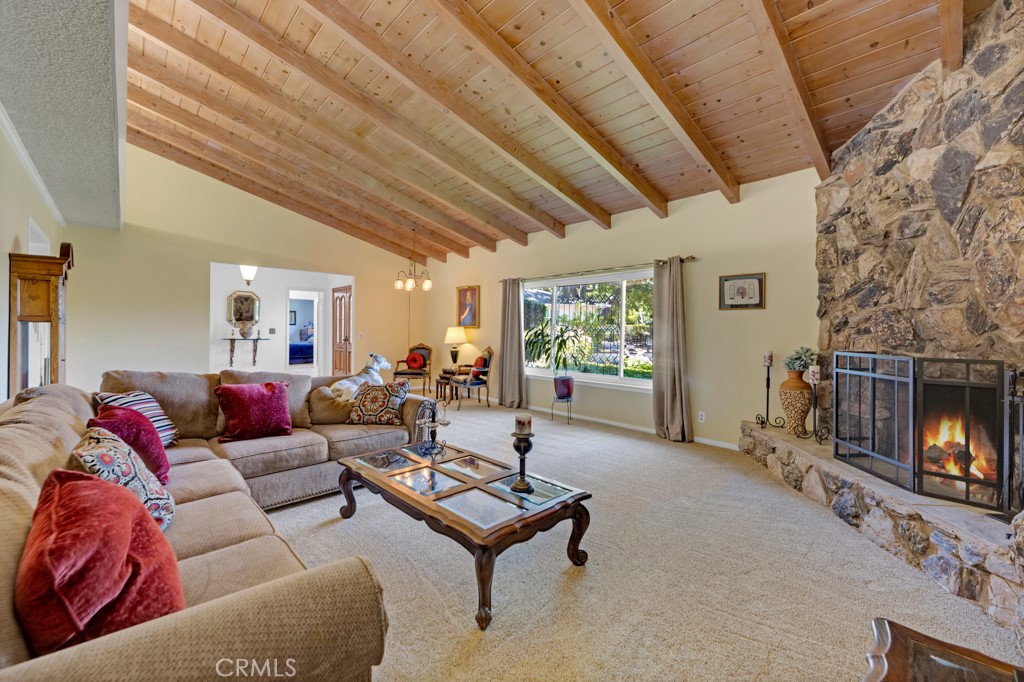 23714 Lawnside Drive Newhall, CA 91321 - Photo 20 of 48 a living room with furniture a fireplace and a flat screen tv
