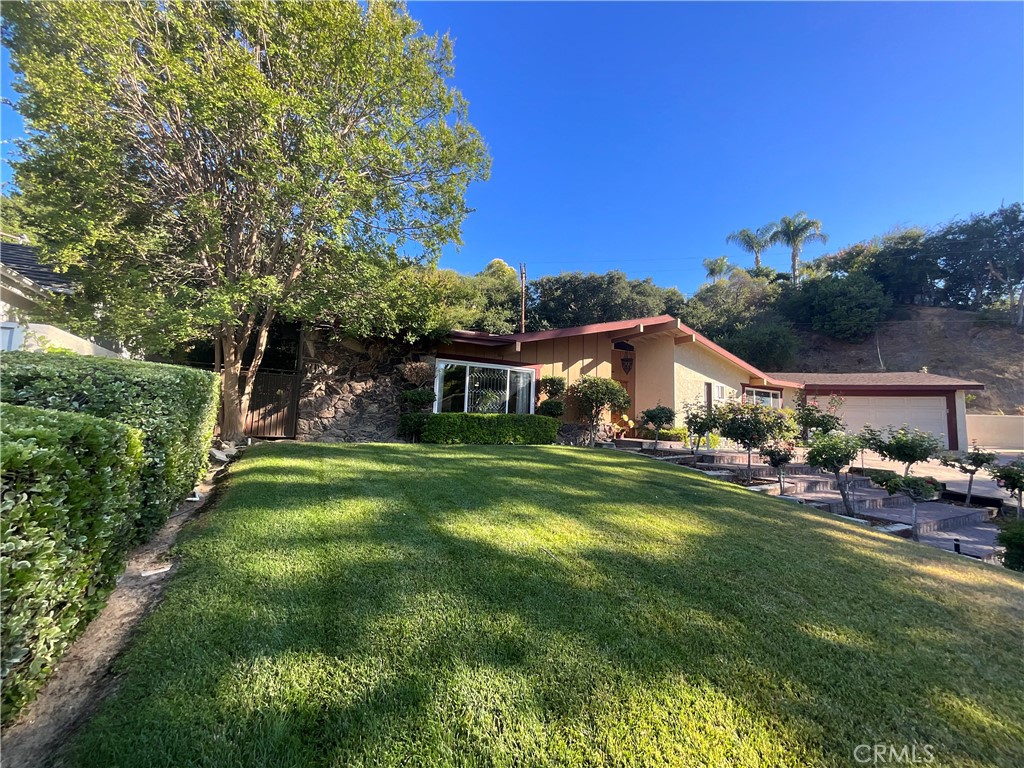 23714 Lawnside Drive Newhall, CA 91321 - Photo 3 of 48 a front view of a house with garden