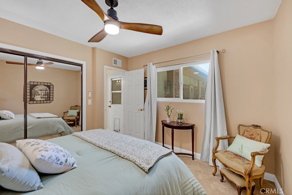 23714 Lawnside Drive Newhall, CA 91321 - Photo 31 of 48 a bedroom with a bed and wooden floor