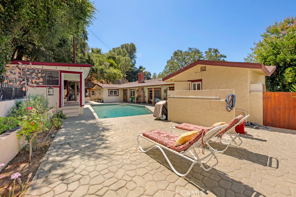 23714 Lawnside Drive Newhall, CA 91321 - Photo 36 of 48 a view of a patio with a table and chairs under an umbrella
