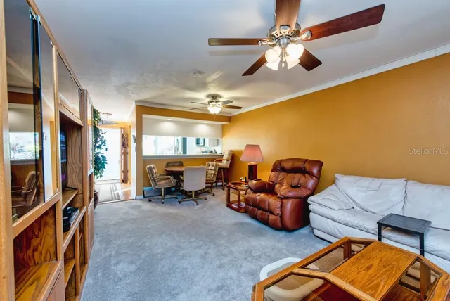 a living room with furniture a fireplace and a chandelier