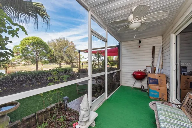 a view of a porch with furniture and garden
