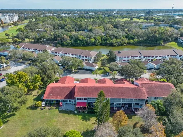 an aerial view of lake residential house with swimming pool and outdoor space