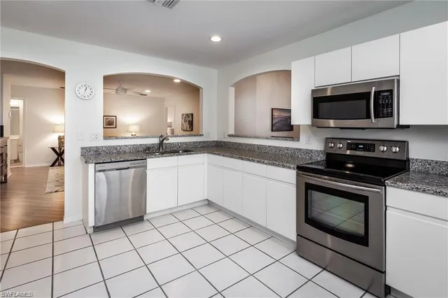 a kitchen with a sink stove and microwave