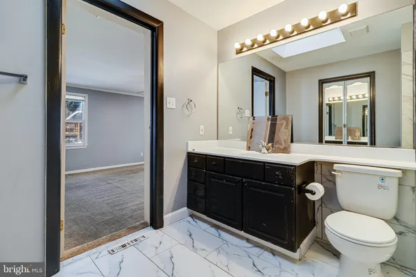 a bathroom with a sink vanity and a mirror