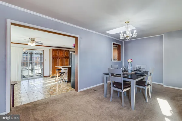a view of a dining room with furniture and chandelier