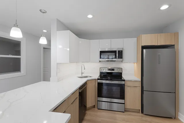 a kitchen with a refrigerator stove and microwave