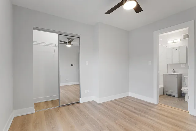 an empty room with closet and windows