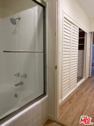 a bathroom with a bathtub and shower