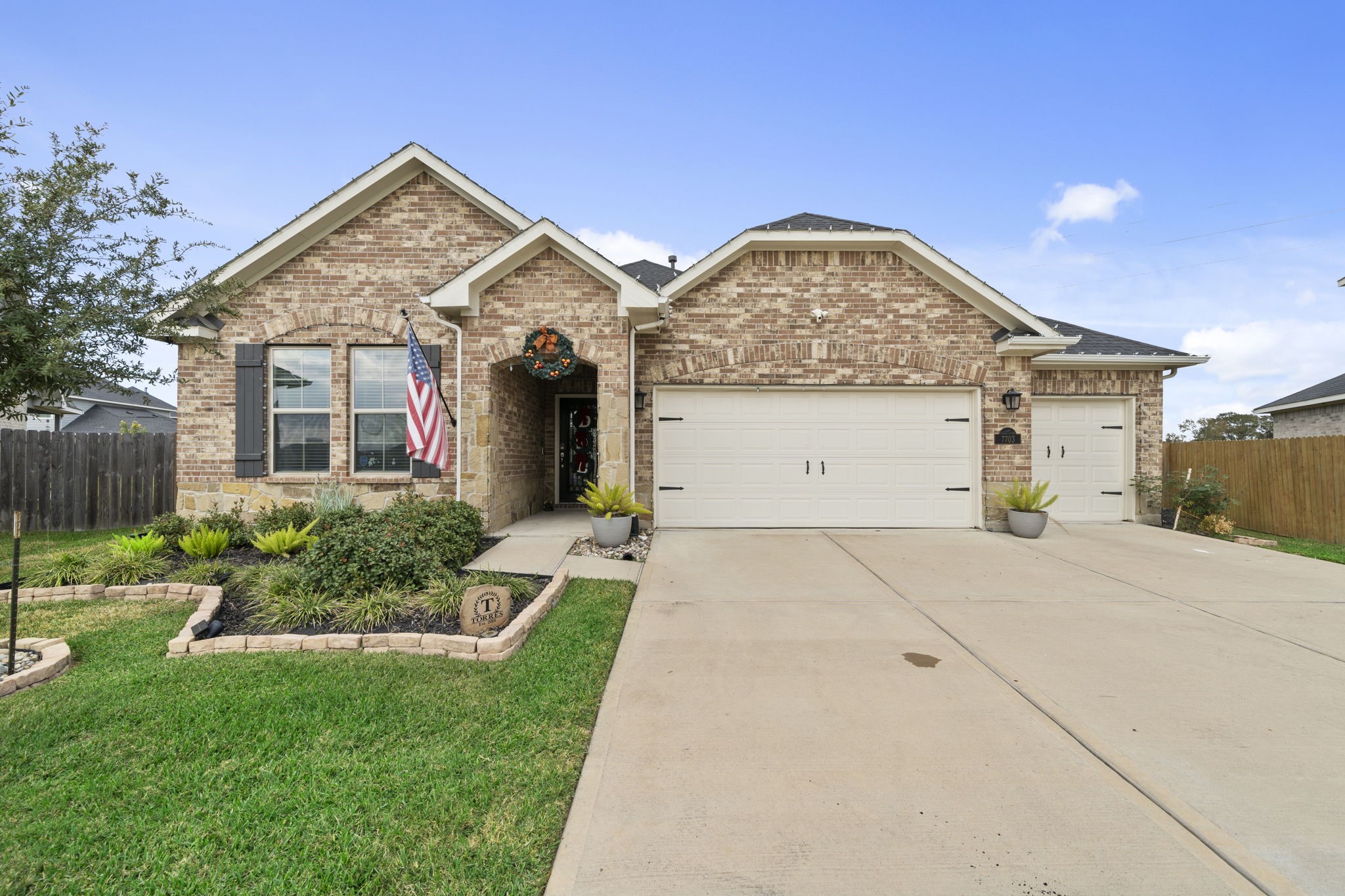 a front view of house with a garden
