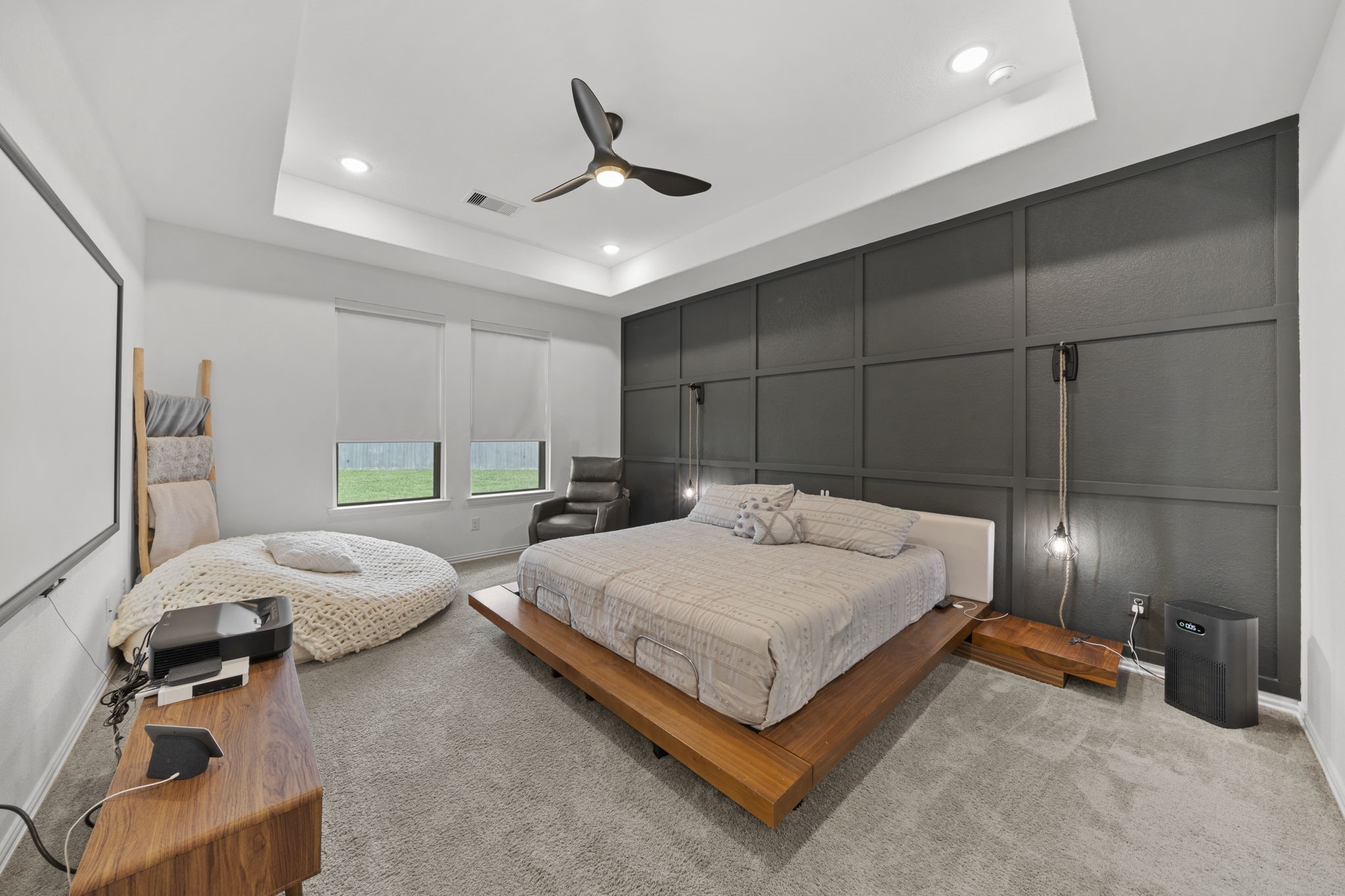 7703 Cowdray Lane Fulshear, TX 77441 - Photo 11 of 15 a bedroom with a bed and a chandelier