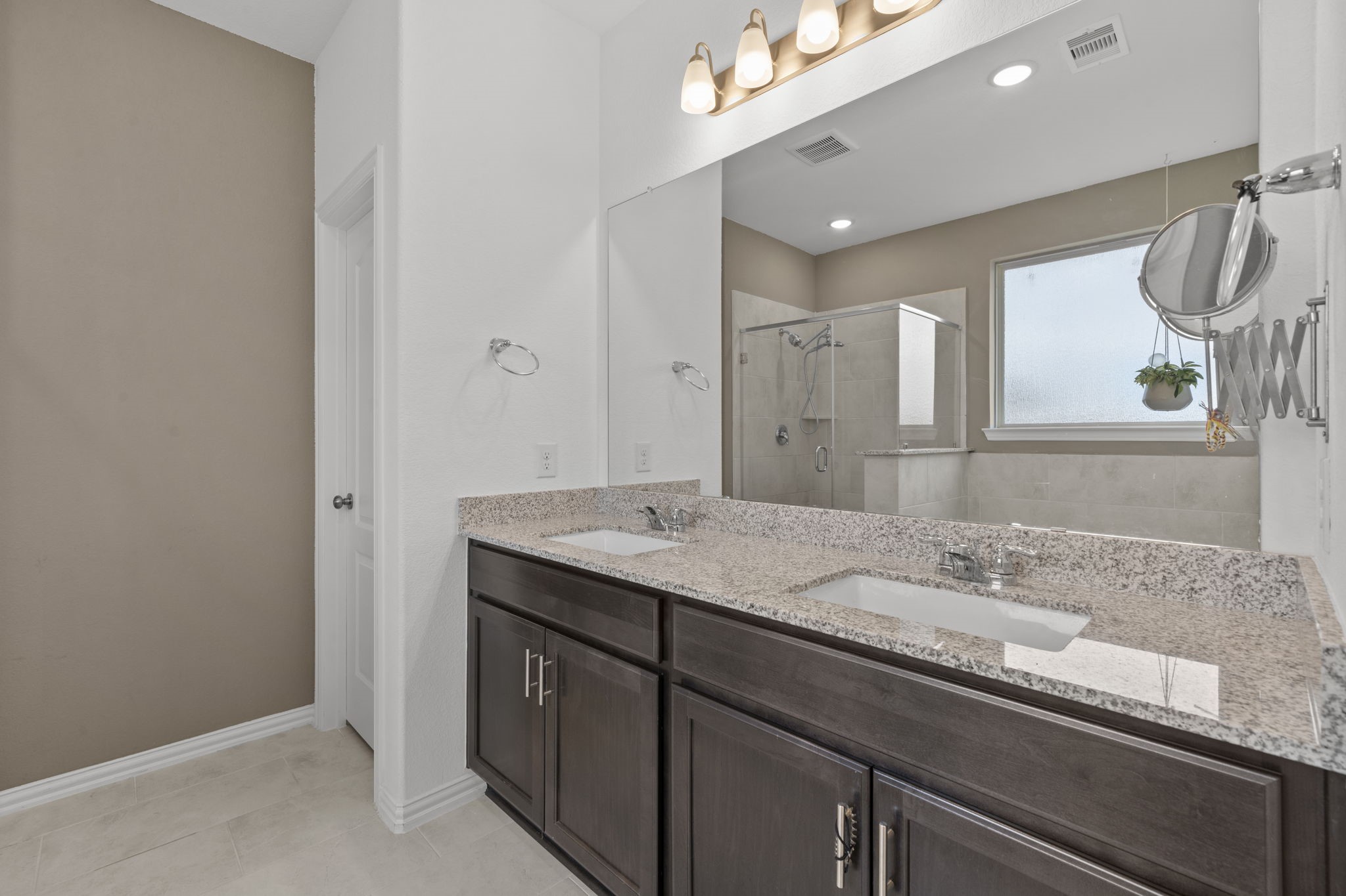 7703 Cowdray Lane Fulshear, TX 77441 - Photo 12 of 15 a bathroom with a granite countertop sink a large mirror and vanity
