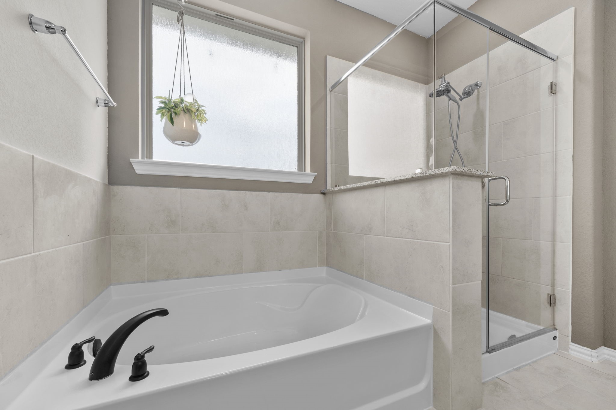 7703 Cowdray Lane Fulshear, TX 77441 - Photo 13 of 15 a bathroom with a tub and a window