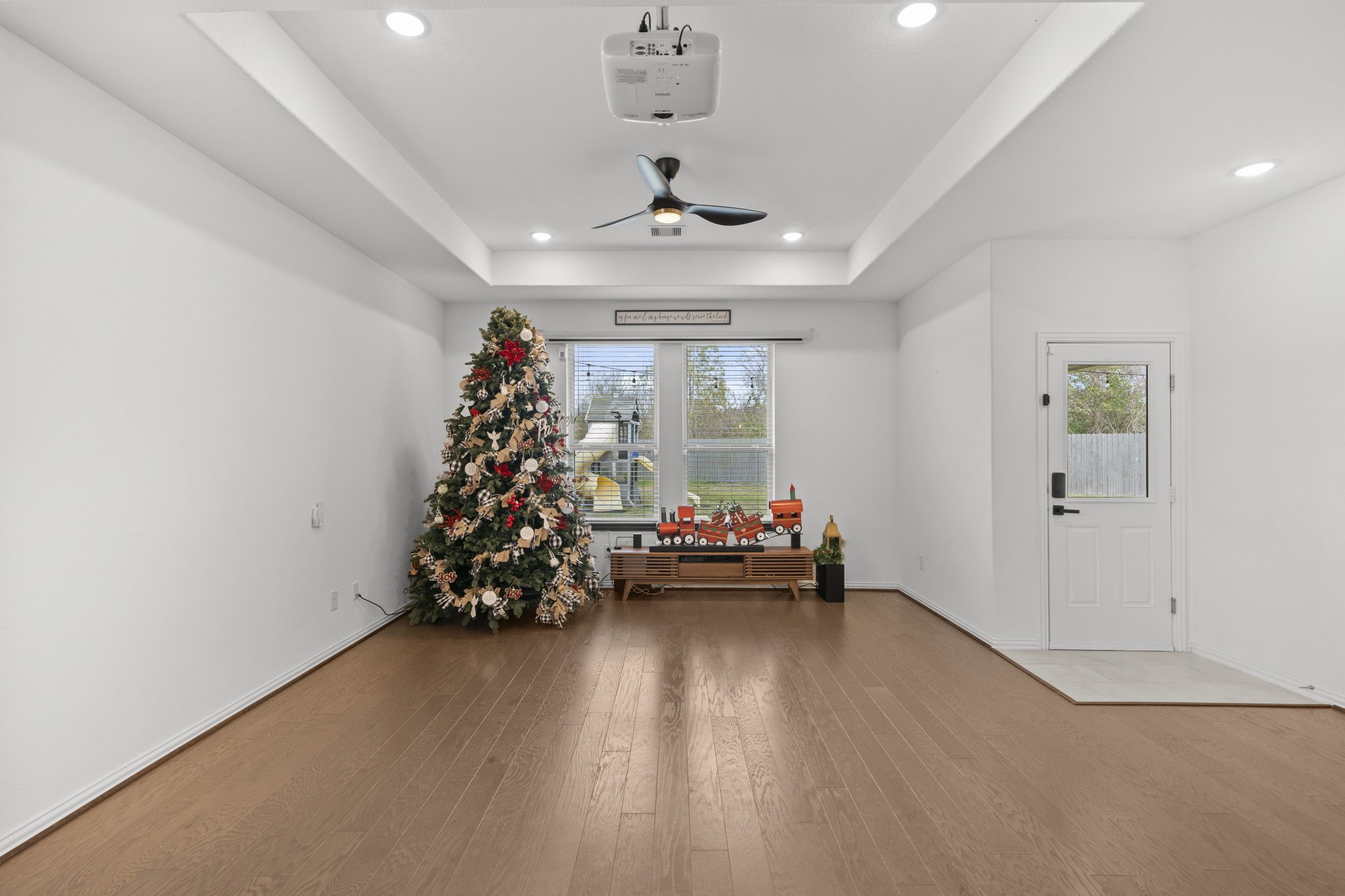 7703 Cowdray Lane Fulshear, TX 77441 - Photo 5 of 15 a view of a room with wooden floor and window