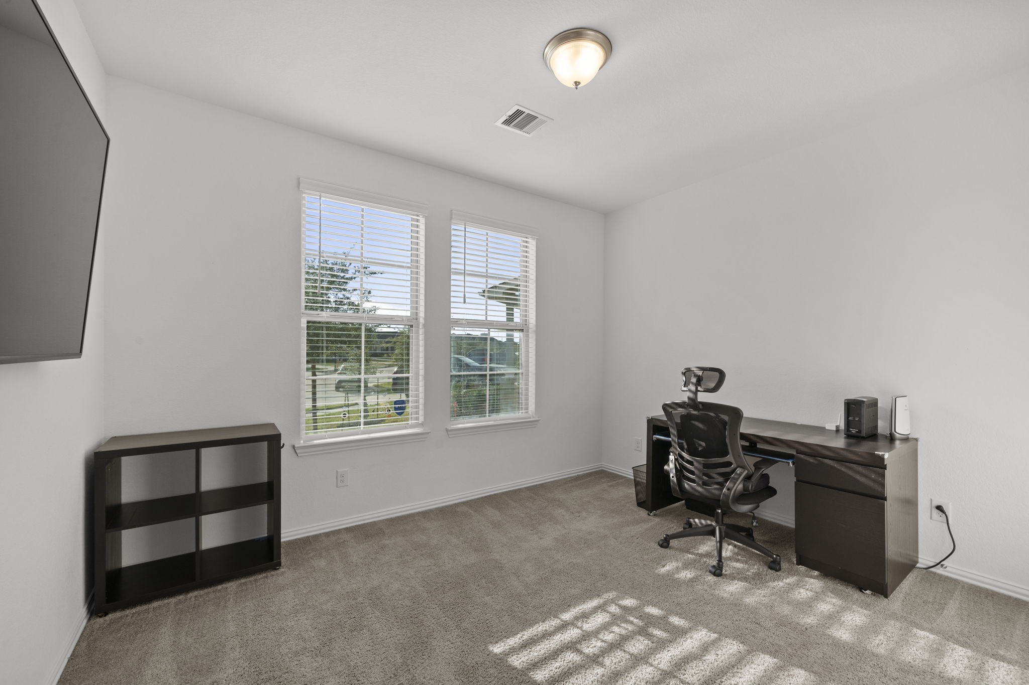 7703 Cowdray Lane Fulshear, TX 77441 - Photo 6 of 15 a workspace with furniture and a window