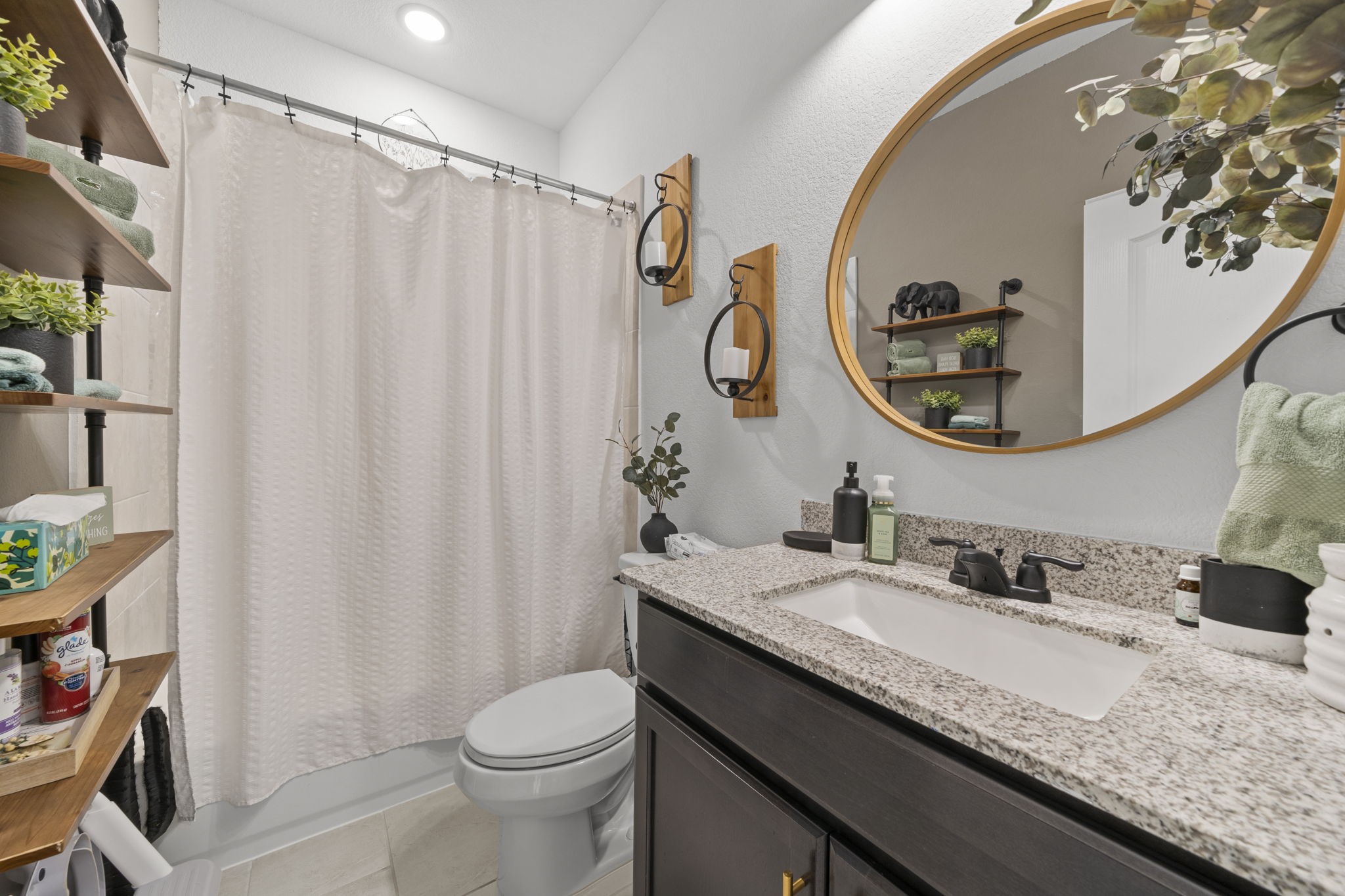 7703 Cowdray Lane Fulshear, TX 77441 - Photo 7 of 15 a bathroom with a granite countertop sink and a mirror