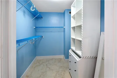 a view of storage and utility room with closet