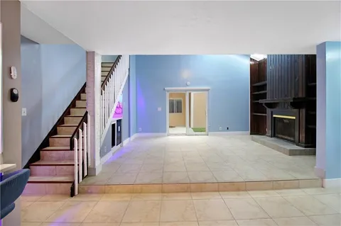 wooden floor in an empty room with a fireplace