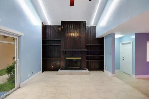 a view of an empty room with a fireplace