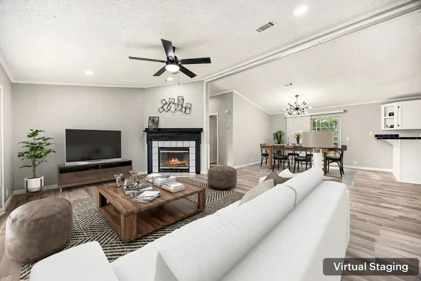 a living room with furniture a fireplace and a flat screen tv