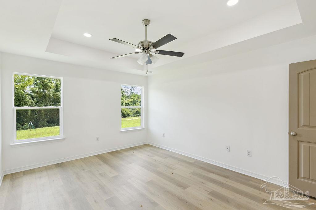 5594 Wiley Scott Road Jay, FL 32565 - Photo 11 of 22 an empty room with windows and fan