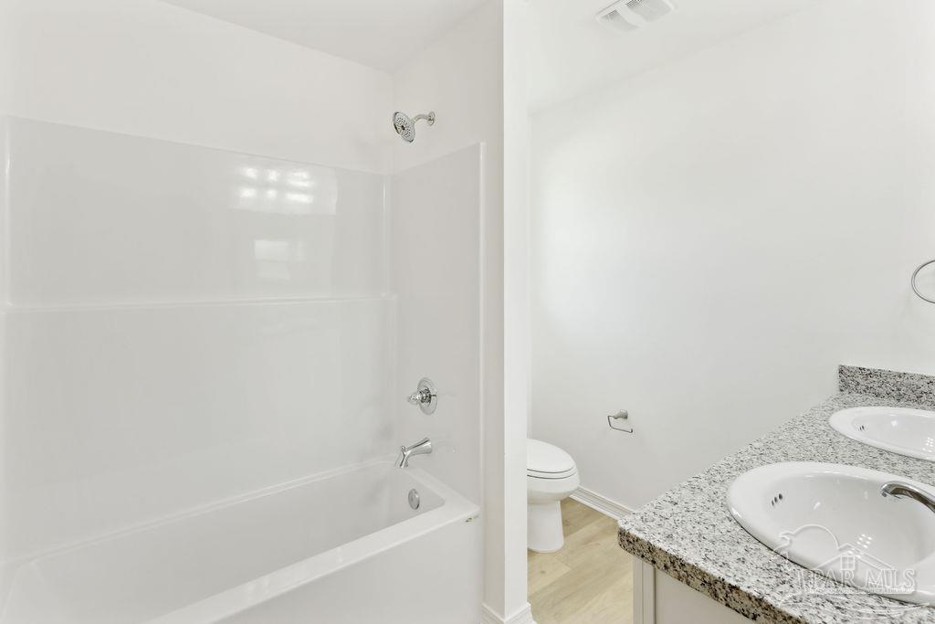 5594 Wiley Scott Road Jay, FL 32565 - Photo 12 of 22 a bathroom with a granite countertop sink a toilet and bathtub