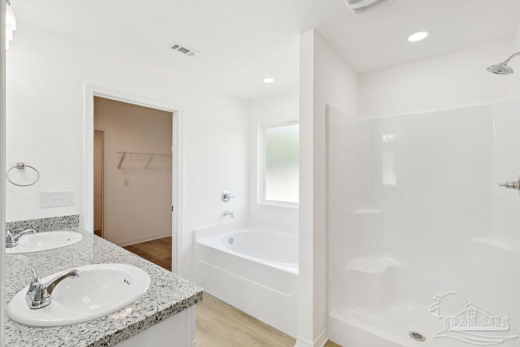 5594 Wiley Scott Road Jay, FL 32565 - Photo 14 of 22 a bathroom with a granite countertop sink a mirror and a bathtub