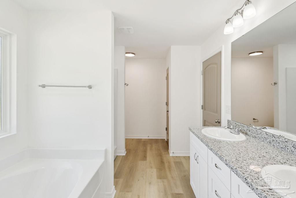 5594 Wiley Scott Road Jay, FL 32565 - Photo 15 of 22 a bathroom with a granite countertop sink a mirror and a bathtub