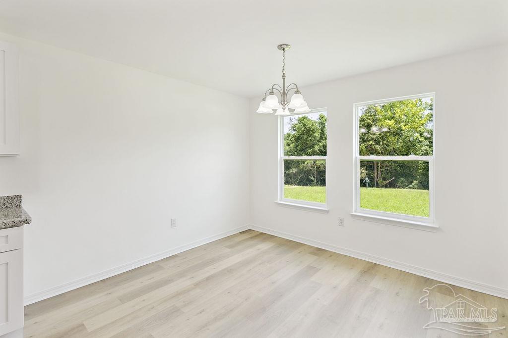 5594 Wiley Scott Road Jay, FL 32565 - Photo 19 of 22 a view of an empty room with windows