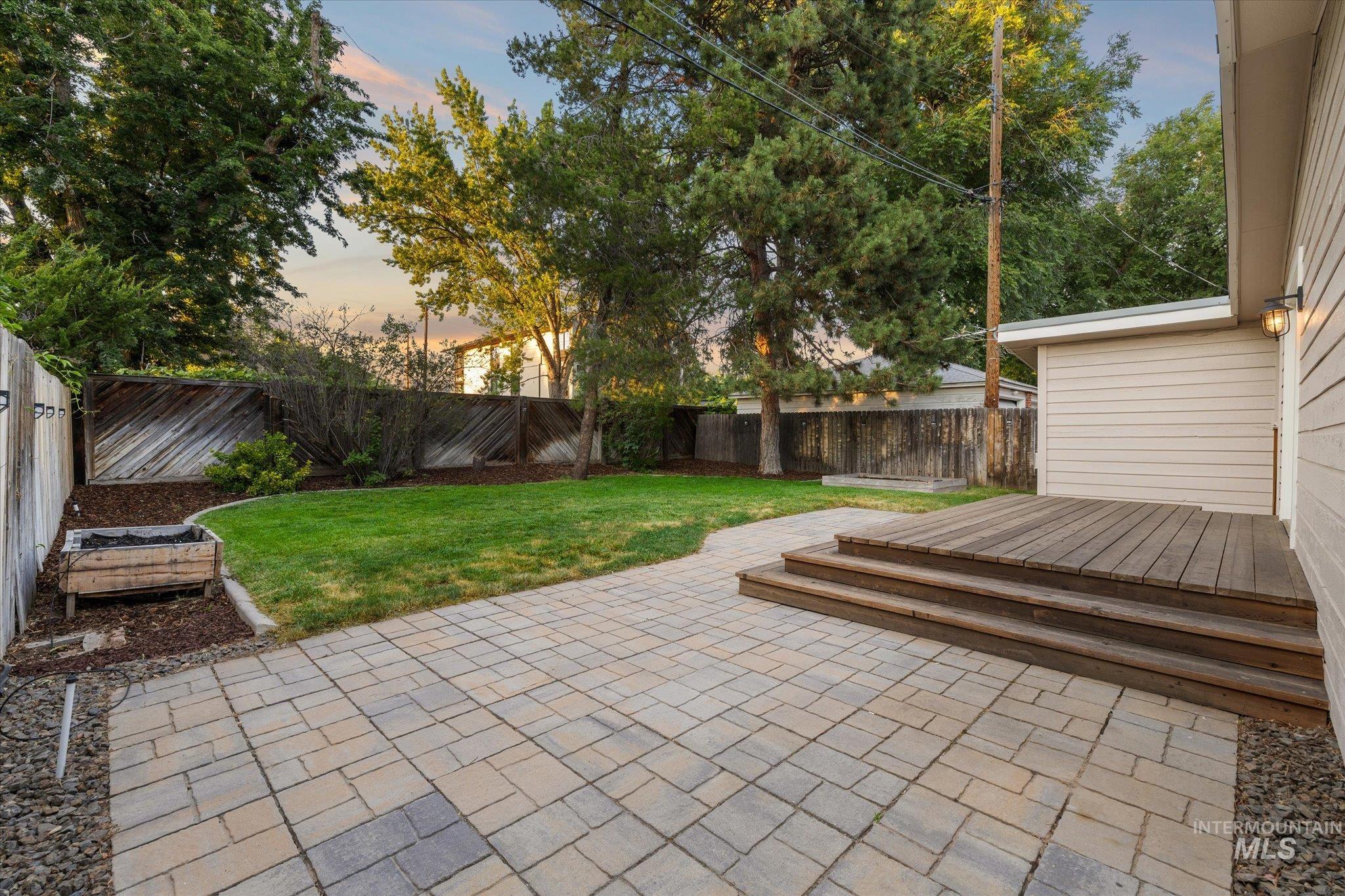 2302 Pendleton Street Boise, ID 83705 - Photo 29 of 35 Backyard featuring a paver patio, multi-level wood deck, manicured lawn, wood fencing, and mature trees